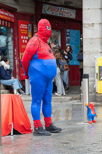Costumed Street Performers walk in Hollywood, Los Angeles, California, USA on a cloudy day.