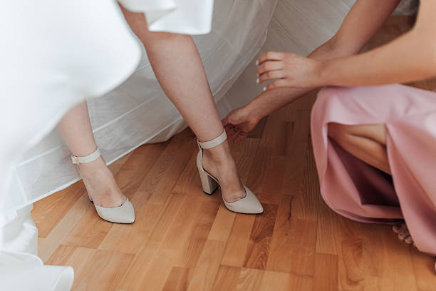 istock A woman is getting her shoes fixed by another woman 2211920921