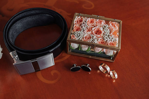 istock A man's belt and a box of flowers sit on a table 2211920926