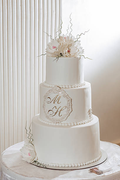 istock A white wedding cake with a white ribbon and a gold border 2211921044