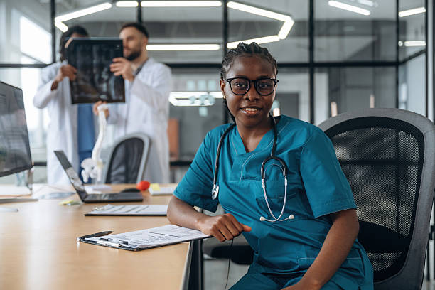 istock Men behind are looking at x-ray. Doctors are working in the office 2211922129