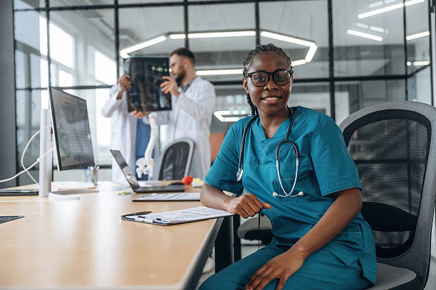 istock Men behind are looking at x-ray. Doctors are working in the office 2211922131