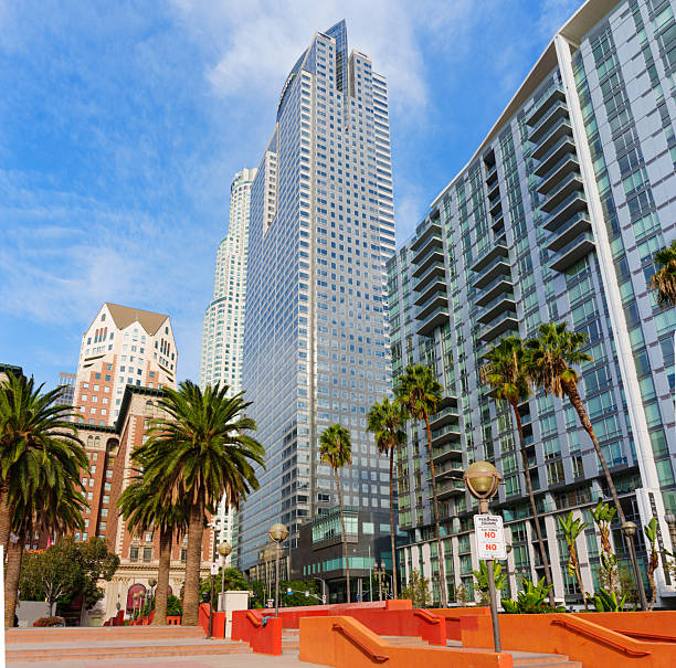 Los Angeles, California - December 3, 2024: Clear view of the Gas Company Tower and US Bank Tower, surrounded by palm trees and urban landscape in Pershing Square, Los Angeles.