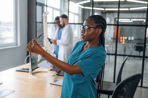 istock Education conception, showing human spine model. Doctors are working in the office 2211922773