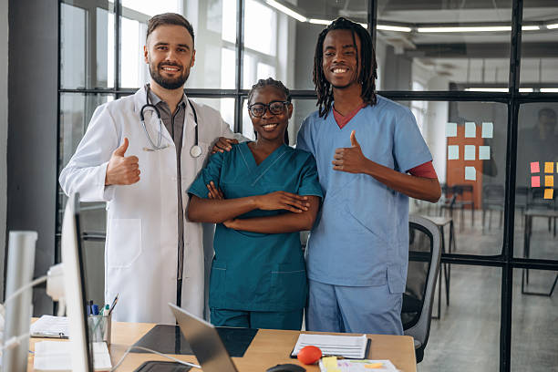 istock Standing and posing. Doctors are working in the office 2211923099