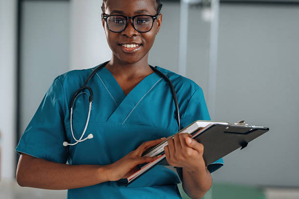 istock Writing information into documents. Female doctor is indoors in modern room 2211925975