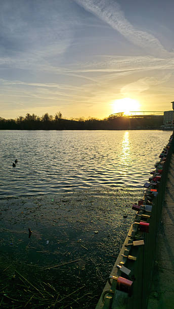 istock Sunset Reflections Over Tranquil Water Surrounded by Love Locks Between Couples and Nature Maschsee Hannover 2211926376