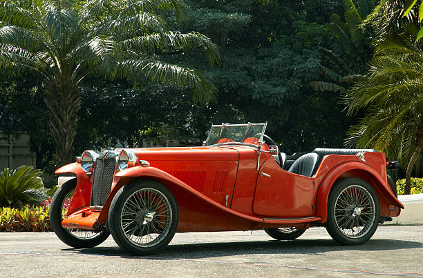 Front view of a grille and headlights of a classic English convertible car