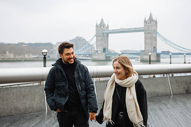 istock Young couple talking and pointing with Tower Bridge in the background 2211928670