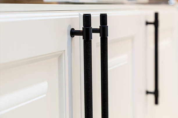 istock Modern black kitchen cabinet handles on white doors 2211928774