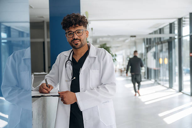 istock Black notepad in hands. Doctor is indoors in the modern building 2211928906