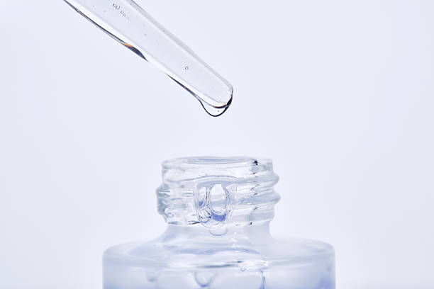 istock The blue serum drips from the dropper into the bottle. 2211929703