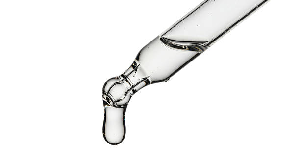istock Isolated Glass Dropper with a Single Dripping Drop 2211930039