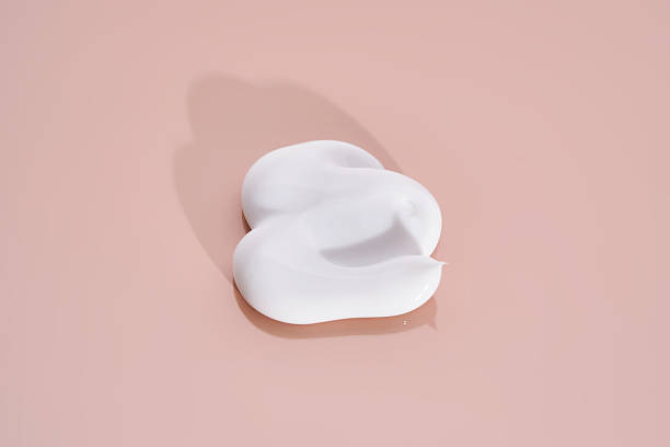 istock The texture of white cream on a pink background. 2211930928
