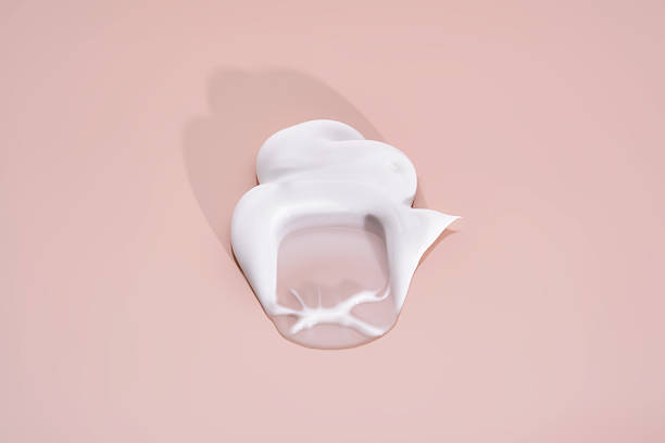 istock The texture of white cream on a pink background. 2211930939