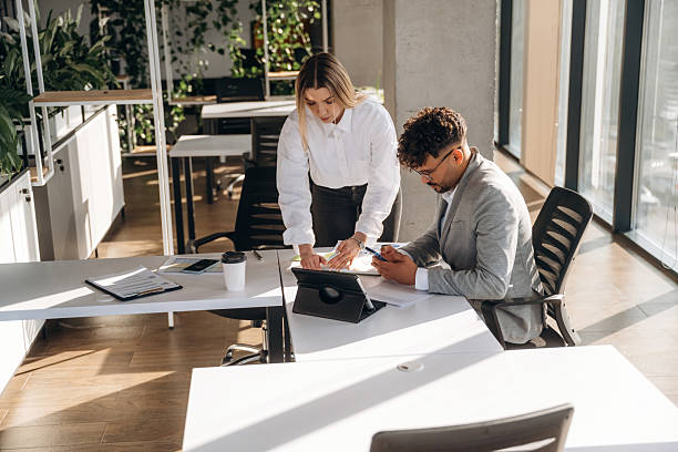 istock Project plan, working. Man and woman are indoors in modern building 2211931234