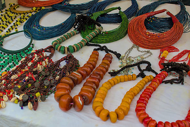 istock An array of colorful and intricately designed necklaces are displayed on a white surface. 2211938893