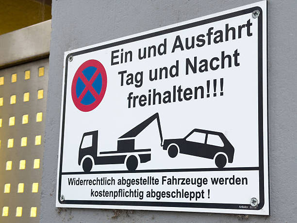 istock German no parking sign warning vehicles will be towed day and night 2211940044