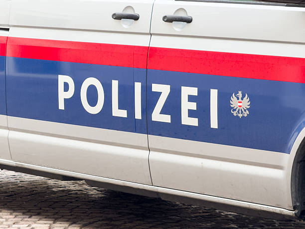 istock Austrian police vehicle side view displaying polizei and national emblem 2211940414