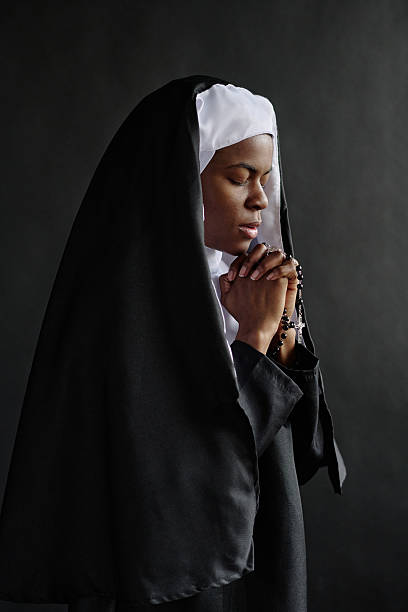 istock Nun Concentrated on Praying 2211942651