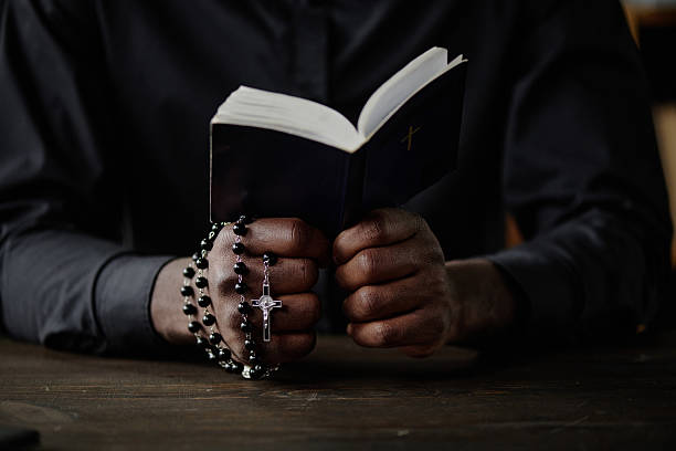 istock Male Hands Holding Bible and Rosary 2211943327