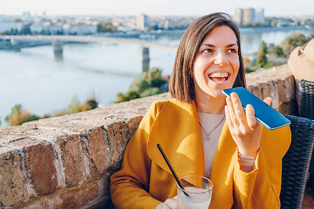 istock Cheerful woman using phone in the city 2211949610
