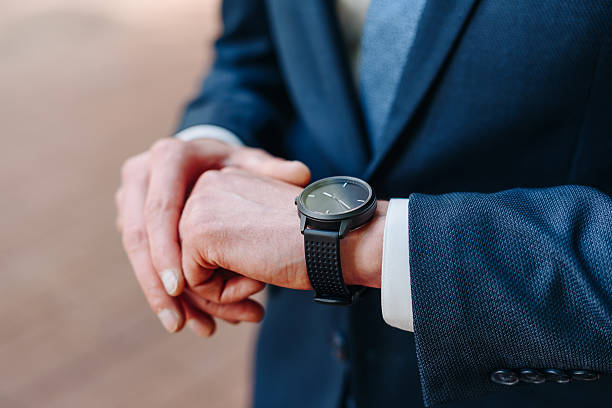 istock man looks at his watch on hand 2211949847