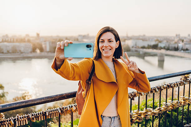 istock Cheerful woman using phone in the city 2211951072