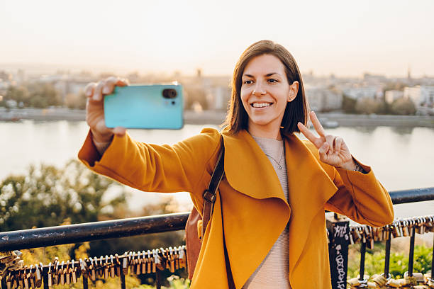istock Cheerful woman using phone in the city 2211951224