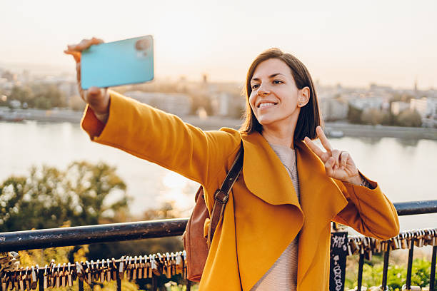 istock Cheerful woman using phone in the city 2211951312