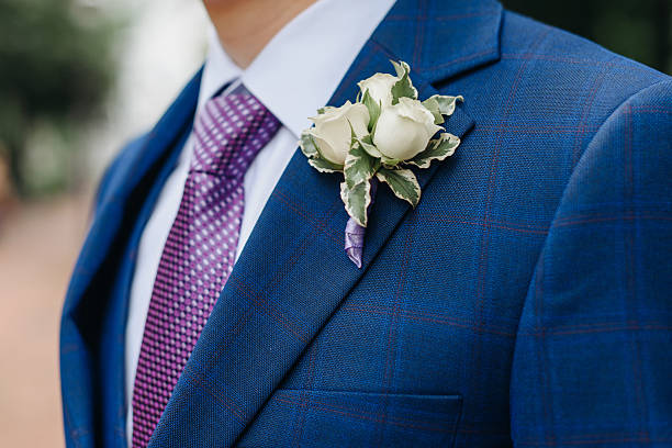 istock white and green boutonniere on groom jacket 2211952810