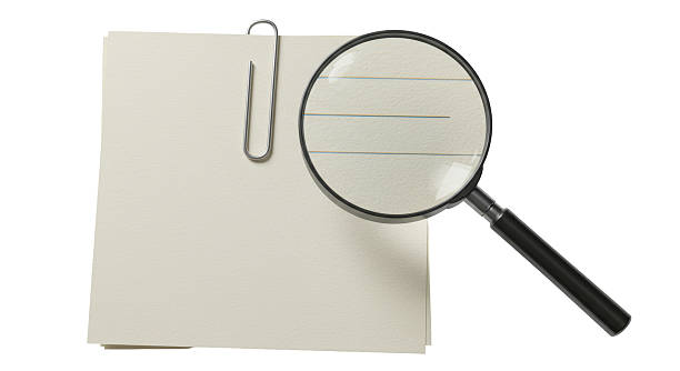 Isolated Magnifying Glass over Blank Note with Paper Clip