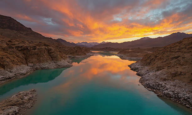 istock A small pool of water in the desert, surrounded by sparse vegetation. 2211955190