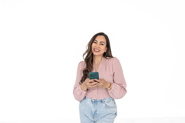 istock Young woman interacting with mobile app on phone against a clean white background 2211956796