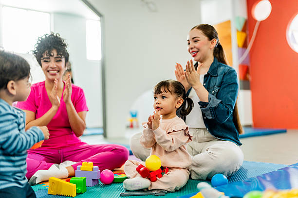 istock Young mother and teacher playing with kids on parents support group 2211956993