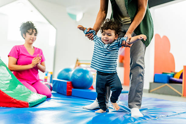 Father playing with baby boy at playroom