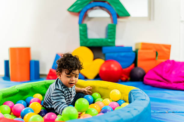 Colorful plastic balls pool background in kid playroom or playground.