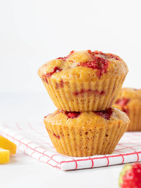 Strawberry lemon muffins on kitchen table with white background and copy space