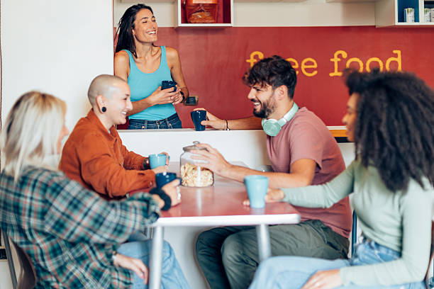 istock Startup team enjoying coffee break and sharing ideas in modern office kitchen 2211958324
