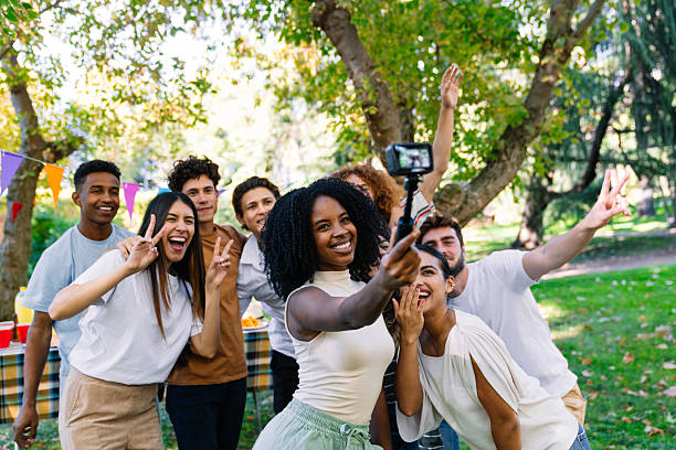 istock Young people taking a selfie at a park party 2211958516