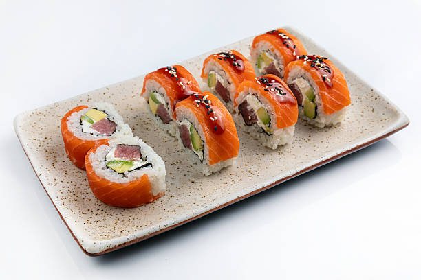 istock Sushi roll with salmon, avocado and cucumber on white background 2211959031
