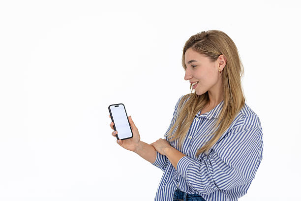 istock Young woman enjoying mobile app interaction against a white background for a modern advertisement 2211960342