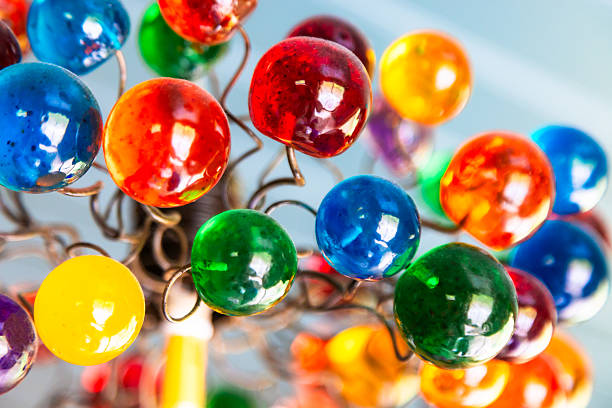 Close up view depicting a group of colorful translucent spheres comprising a light shade.