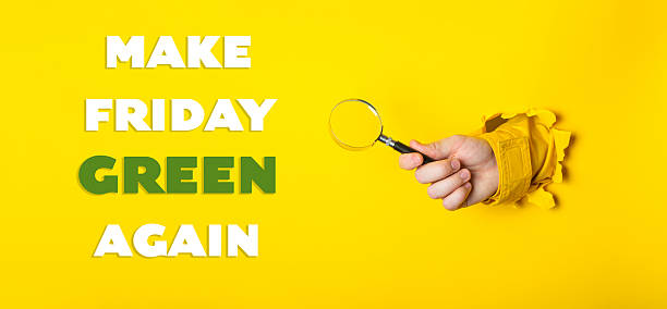 istock Hand holding a magnifying glass with the words Make Friday Green Again written 2211961443