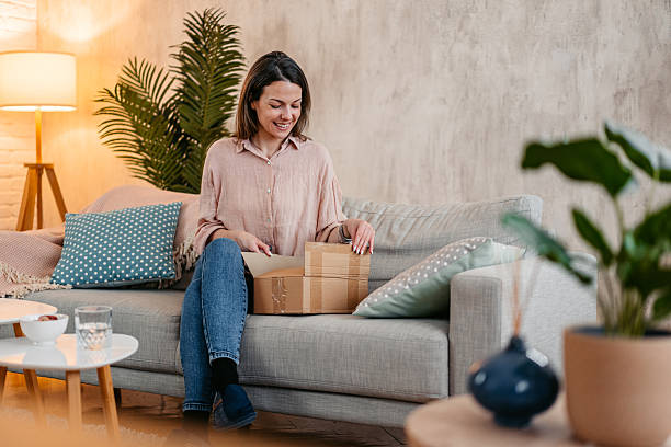 istock Young Woman Unboxing A Package She Ordered Online 2211961582