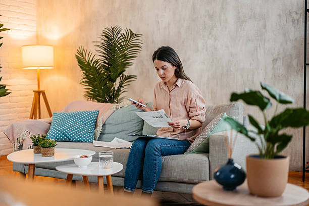 istock Young Woman Checking Her Finances On A Phone At Home 2211962065