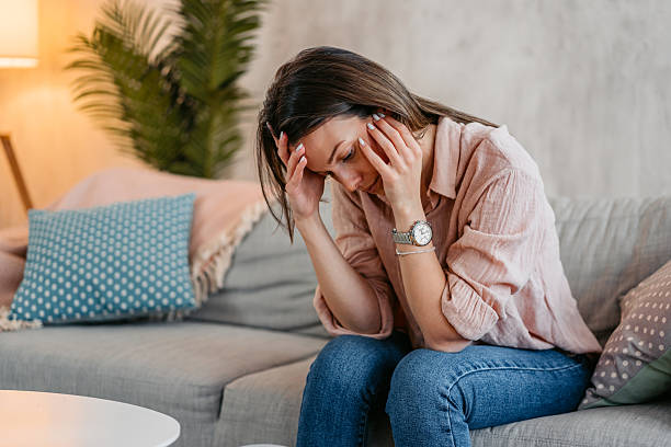 istock Sad Young Woman Sitting At Home On The Sofa 2211962462