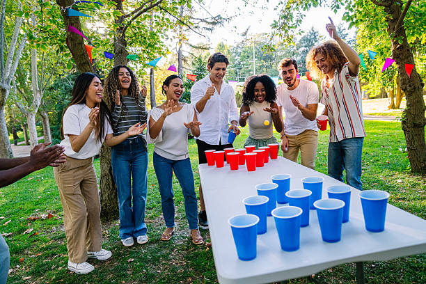 istock Young people playing beer pong outdoors in a park 2211963335