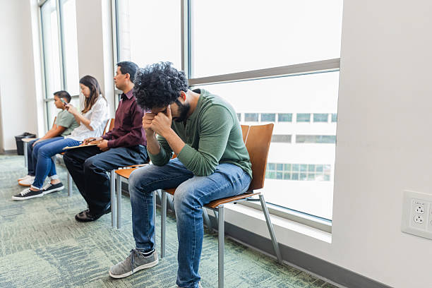 istock Worried Young Man Sitting Alone in a Waiting Room 2211963567