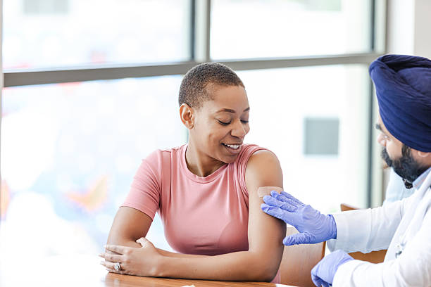 istock Healthcare worker applying bandage after vaccination 2211963624